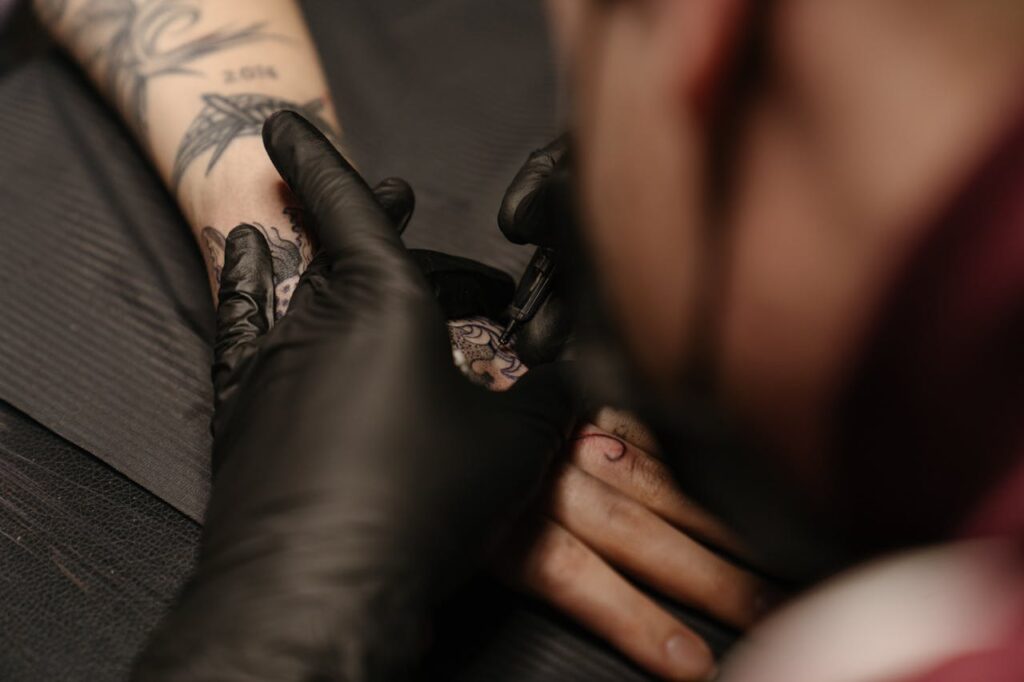 pexels-photo-4125674 Person Wearing Silver Ring With Black Tattoo
